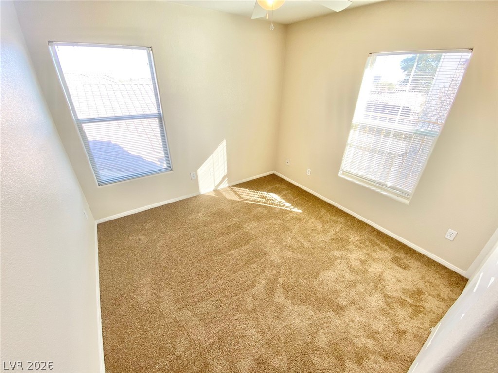 8569 Rhamus Court Las Vegas, NV 89149 - Photo 11 of 35 A quiet retreat with plush carpeting and abundant natural light filtering through dual windows.