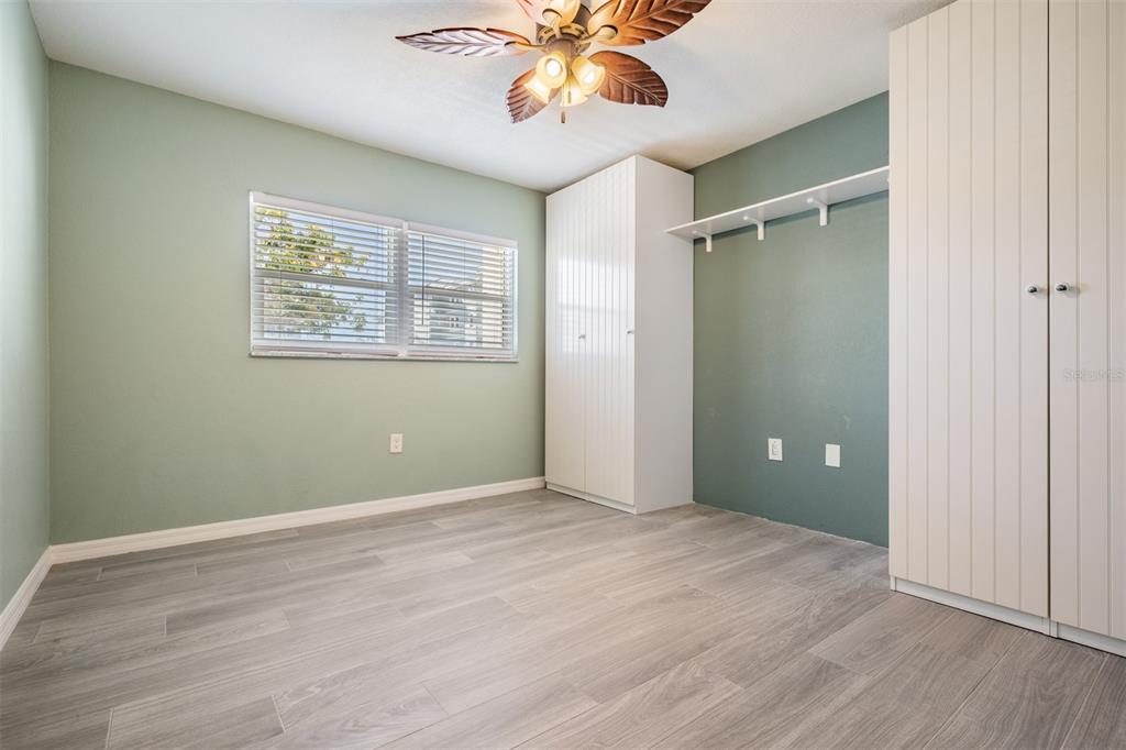 9 Haig Place, Unit 104 Dunedin, FL 34698 - Photo 14 of 59 an empty room with wooden floor closet and windows