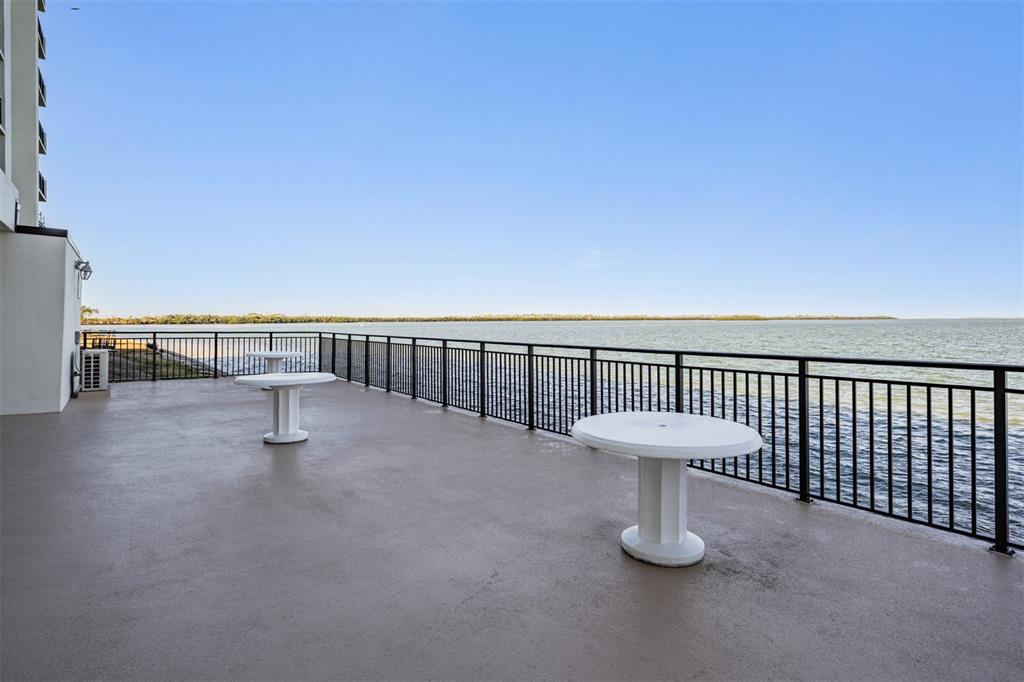 9 Haig Place, Unit 104 Dunedin, FL 34698 - Photo 28 of 59 a view of a terrace with a bench