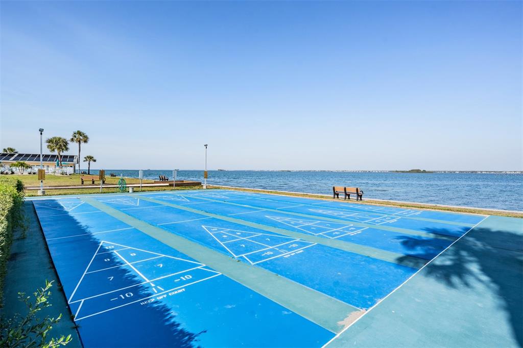 9 Haig Place, Unit 104 Dunedin, FL 34698 - Photo 30 of 59 a view of a swimming pool and an outdoor seating