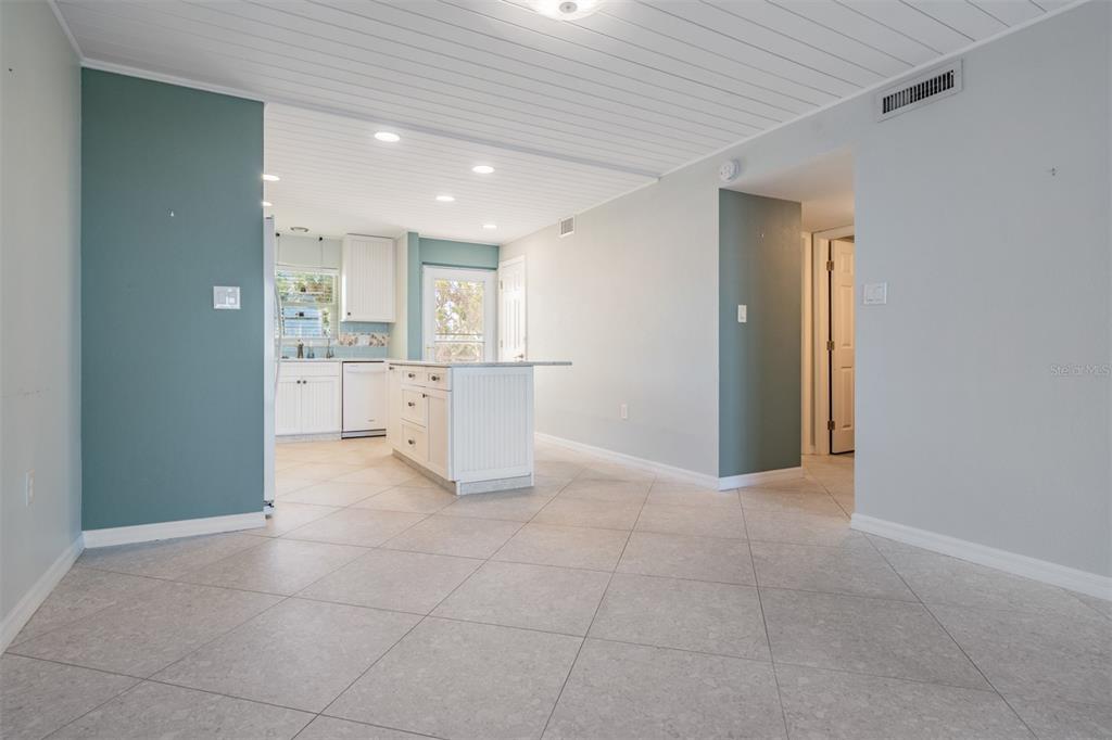 9 Haig Place, Unit 104 Dunedin, FL 34698 - Photo 4 of 59 a view of a kitchen with white cabinets