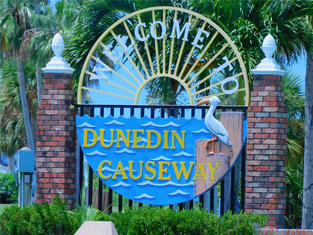 9 Haig Place, Unit 104 Dunedin, FL 34698 - Photo 50 of 59 a sign that is on a brick wall