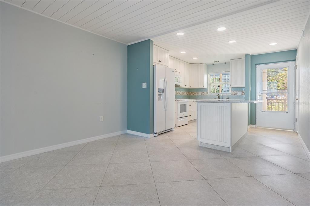 9 Haig Place, Unit 104 Dunedin, FL 34698 - Photo 5 of 59 a kitchen with stainless steel appliances granite countertop a refrigerator and a stove top oven