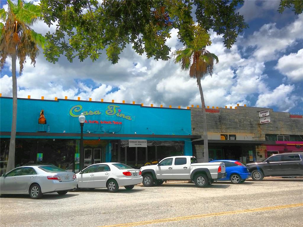 9 Haig Place, Unit 104 Dunedin, FL 34698 - Photo 53 of 59 a cars parked in front of a building