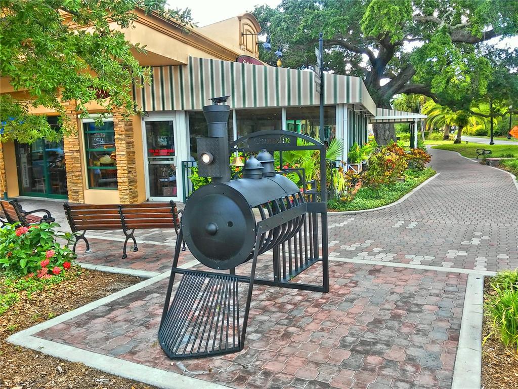 9 Haig Place, Unit 104 Dunedin, FL 34698 - Photo 57 of 59 a view of a chair and table in backyard of the house