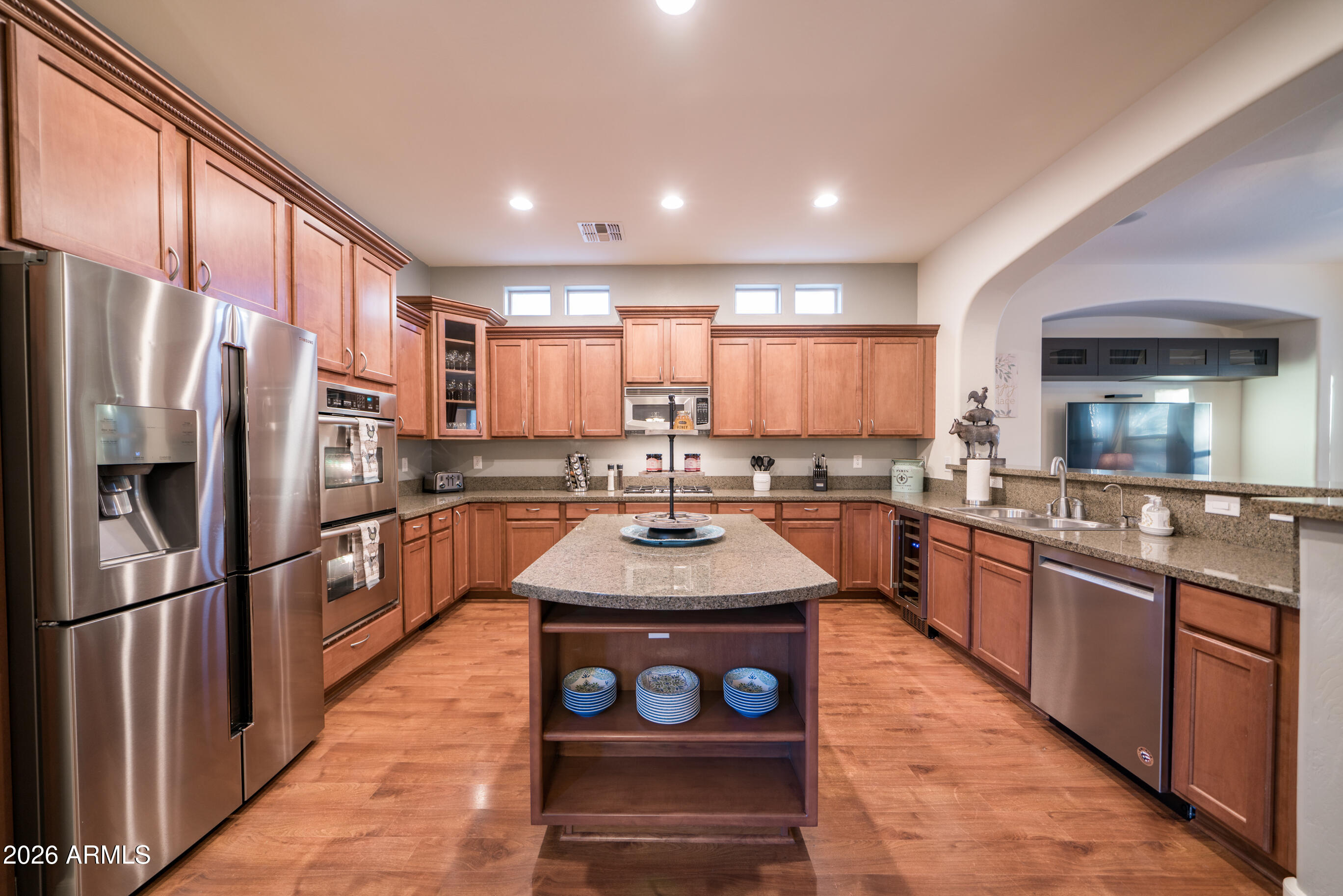 2681 East Hampton Lane Gilbert, AZ 85295 - Photo 11 of 88 a kitchen with stainless steel appliances granite countertop a refrigerator a sink dishwasher a oven with a dining table and chairs
