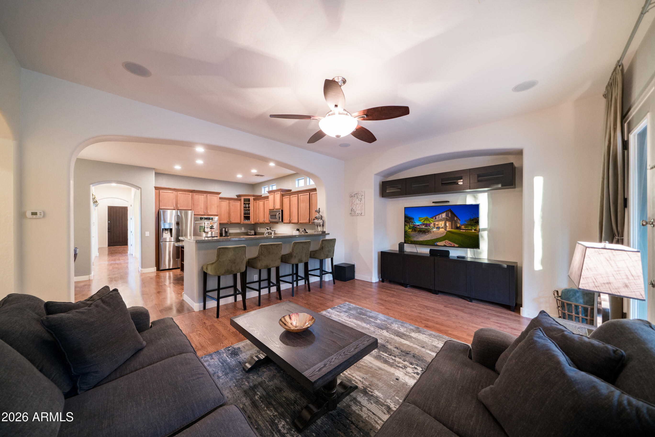 2681 East Hampton Lane Gilbert, AZ 85295 - Photo 20 of 88 a living room with furniture and a flat screen tv with kitchen view