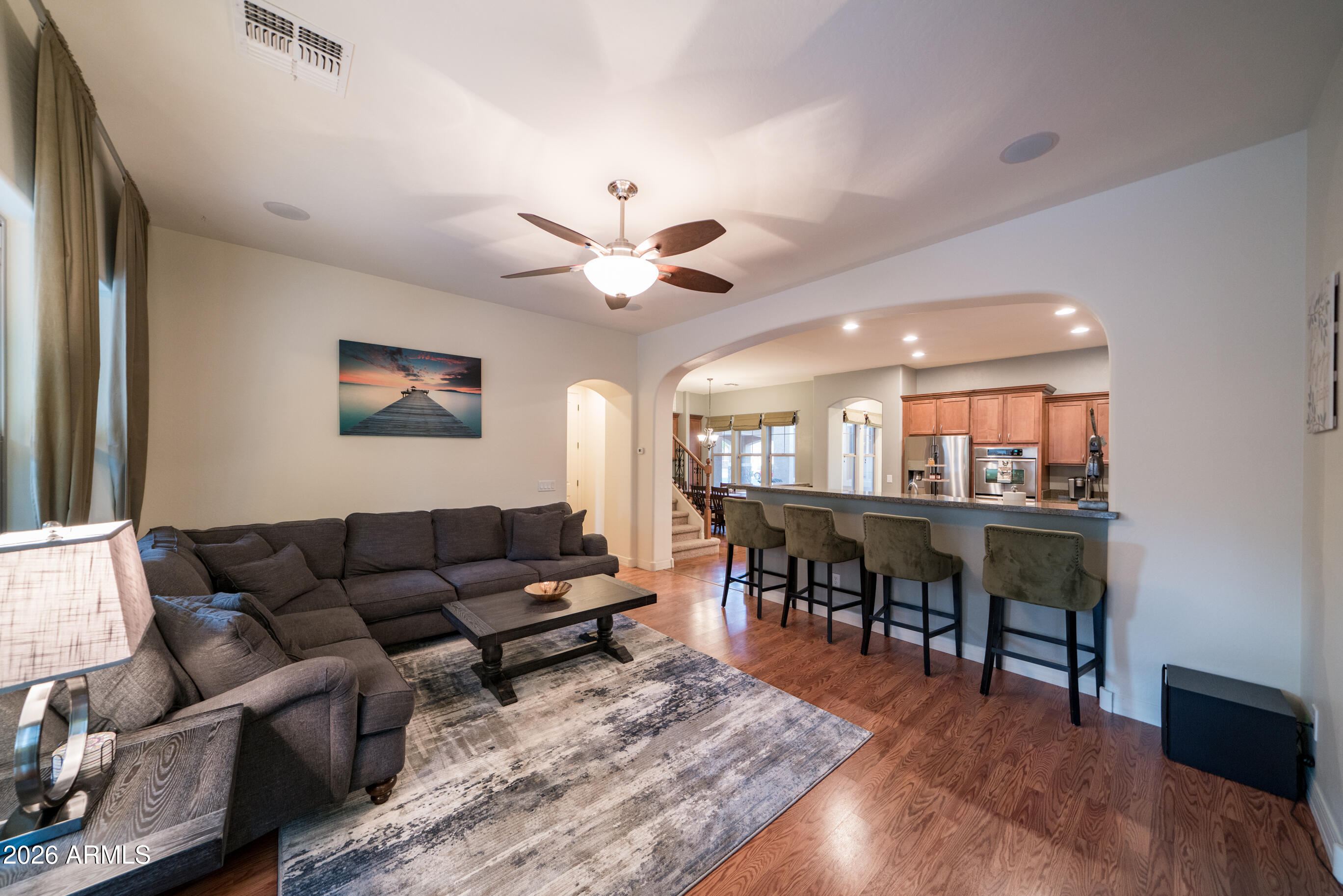 2681 East Hampton Lane Gilbert, AZ 85295 - Photo 22 of 88 a living room with furniture dining table a chandelier and a dining table with wooden floor