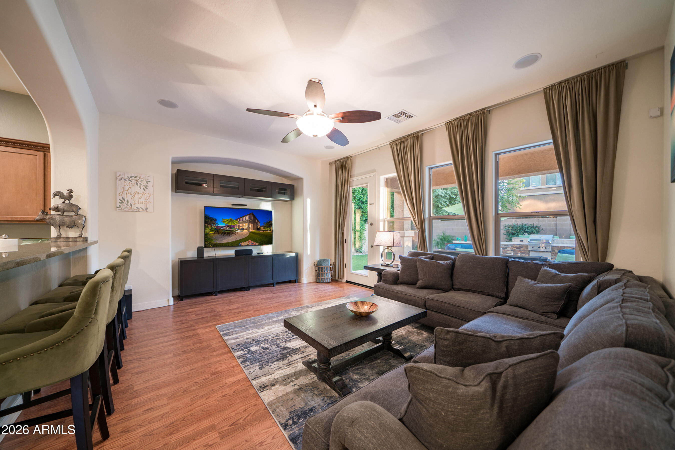 2681 East Hampton Lane Gilbert, AZ 85295 - Photo 23 of 88 a living room with furniture a flat screen tv and a large window