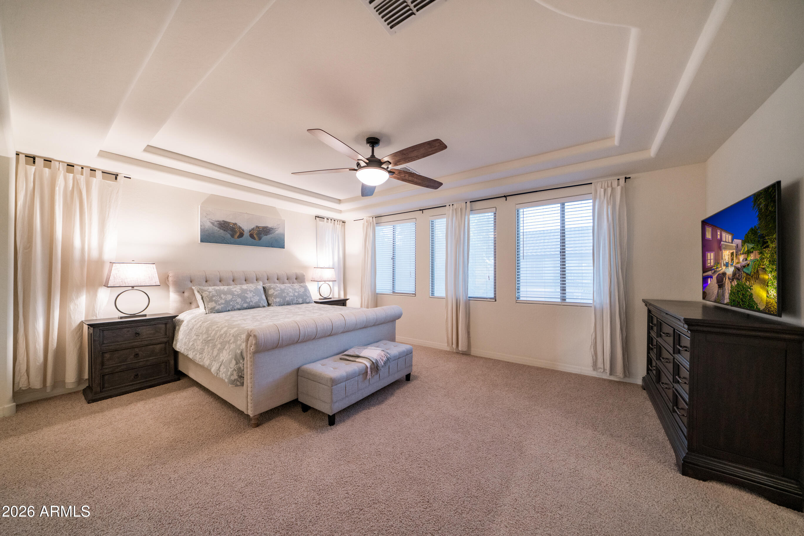 2681 East Hampton Lane Gilbert, AZ 85295 - Photo 31 of 88 a spacious bedroom with a bed and a flat screen tv