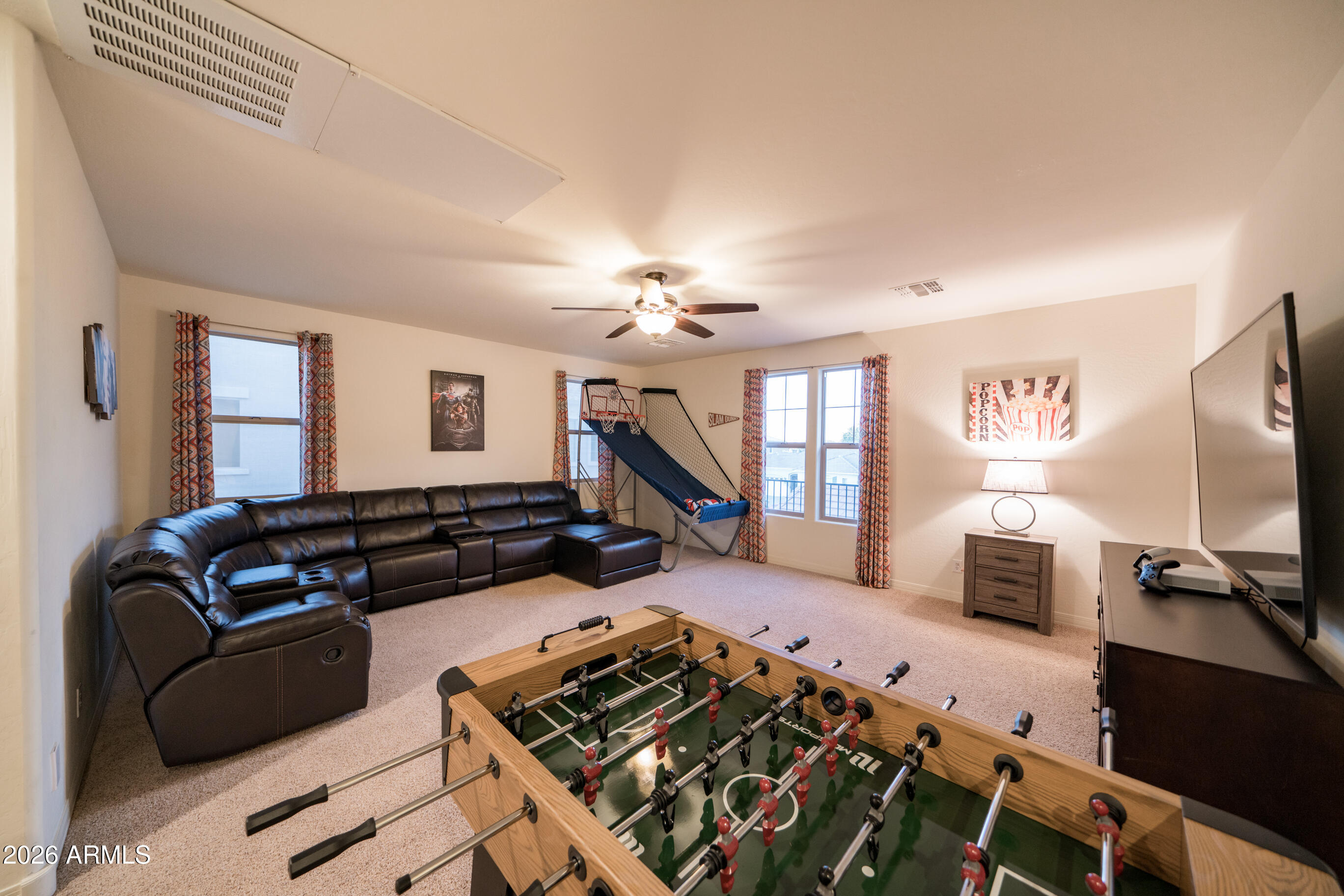 2681 East Hampton Lane Gilbert, AZ 85295 - Photo 40 of 88 a living room with furniture gym equipment and a flat screen tv
