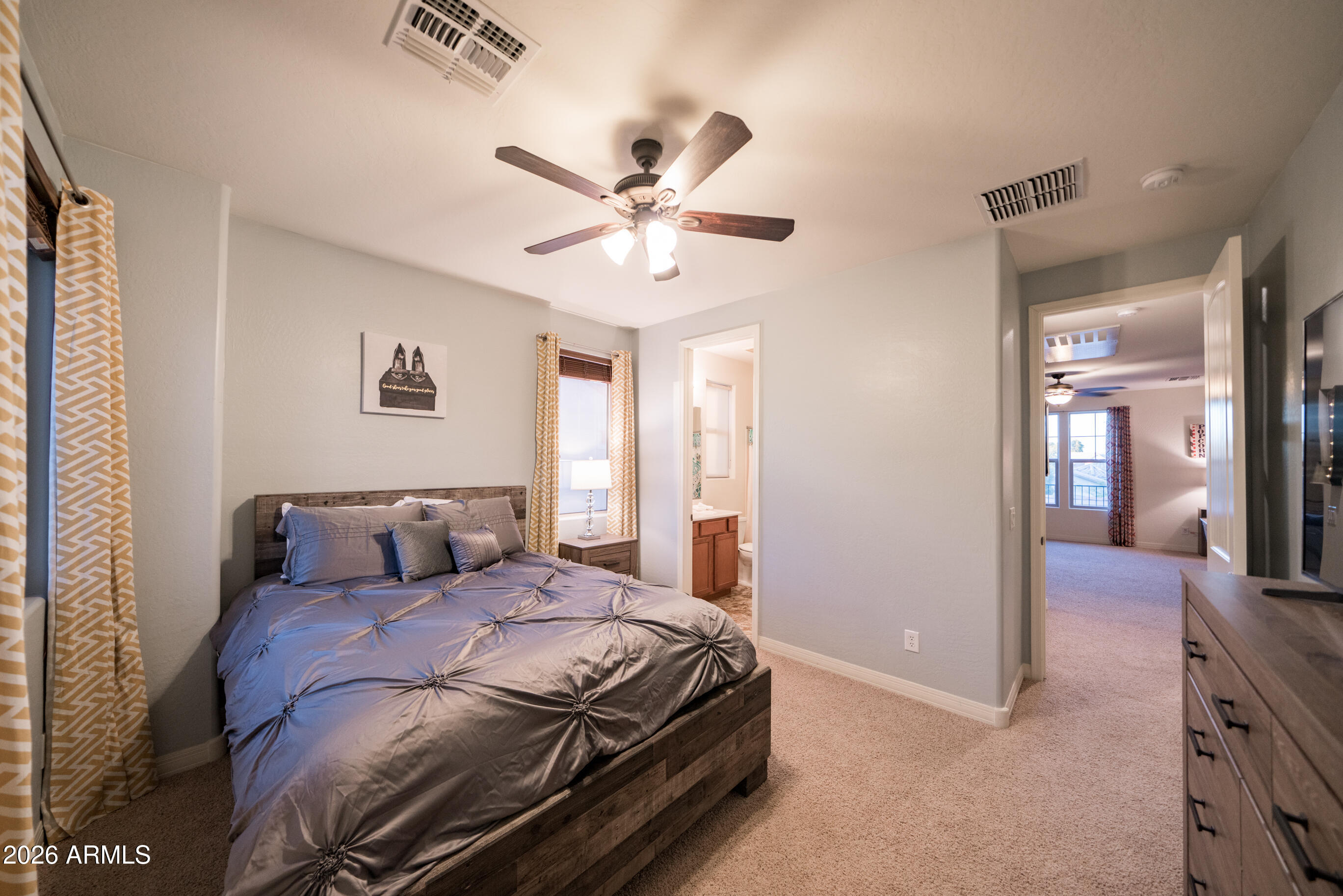 2681 East Hampton Lane Gilbert, AZ 85295 - Photo 44 of 88 a bedroom with a large bed and a chandelier