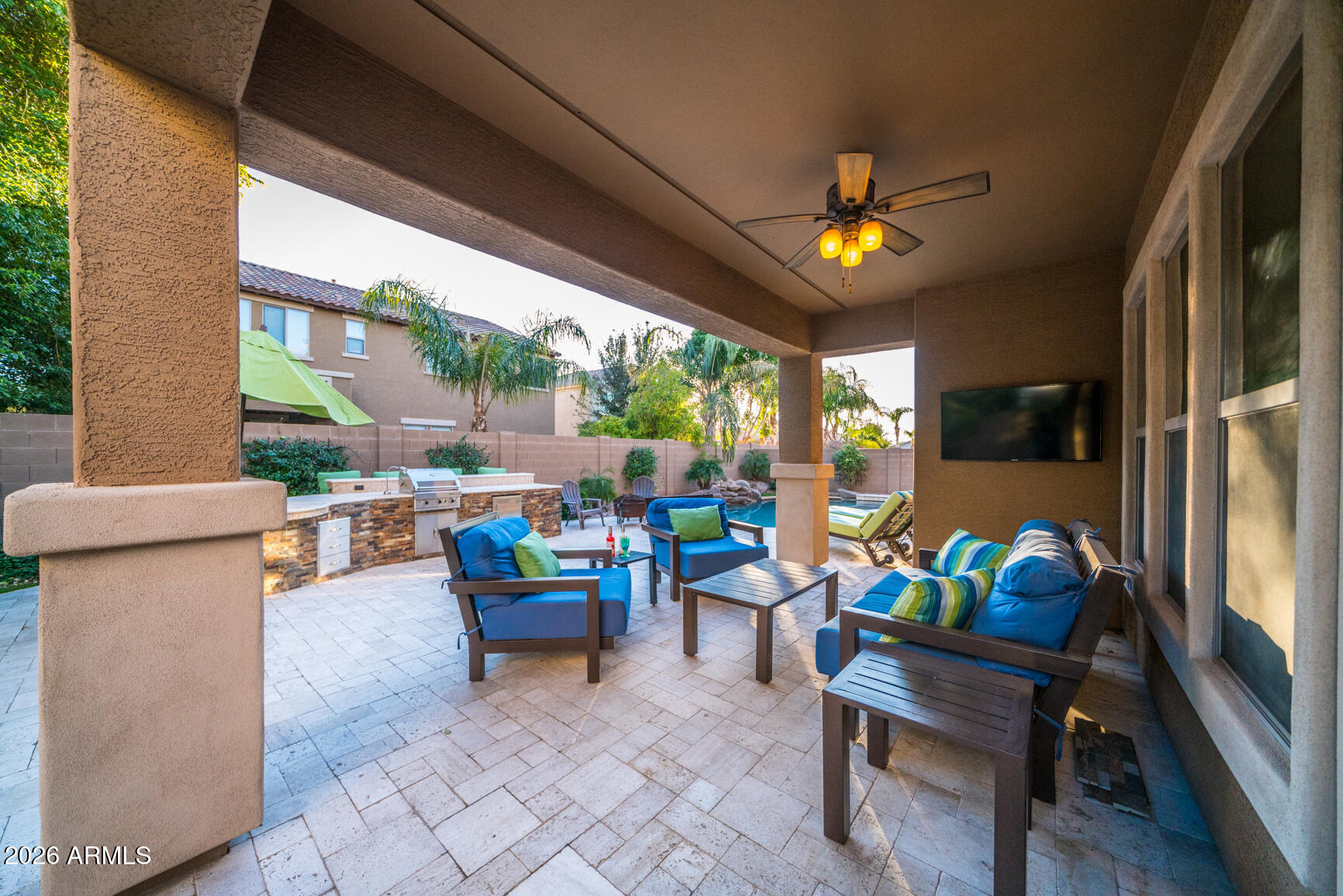 2681 East Hampton Lane Gilbert, AZ 85295 - Photo 72 of 88 a living room with patio furniture and a flat screen tv