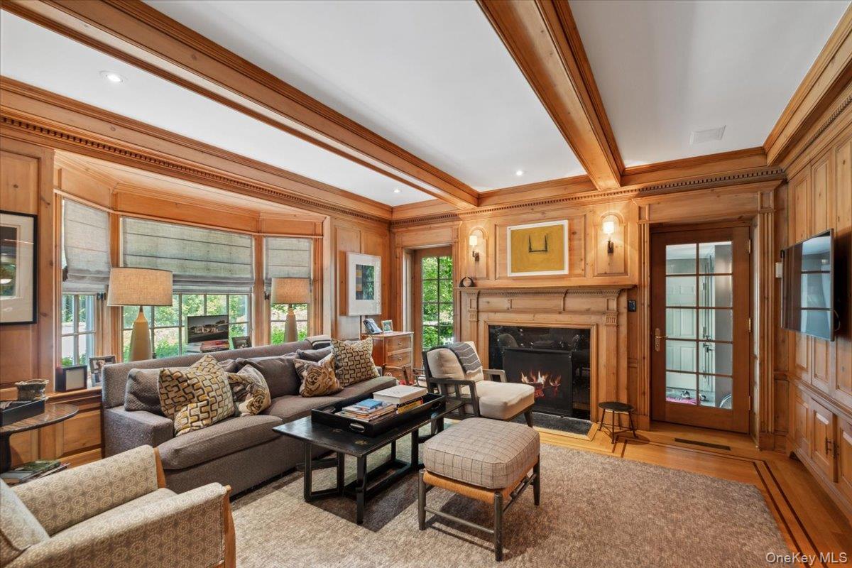 18 Richbell Road Scarsdale, NY 10583 - Photo 19 of 40 A warm, wood paneled study/family room with classic fireplace, French doors to mudroom and flows into the chefs kitchen
