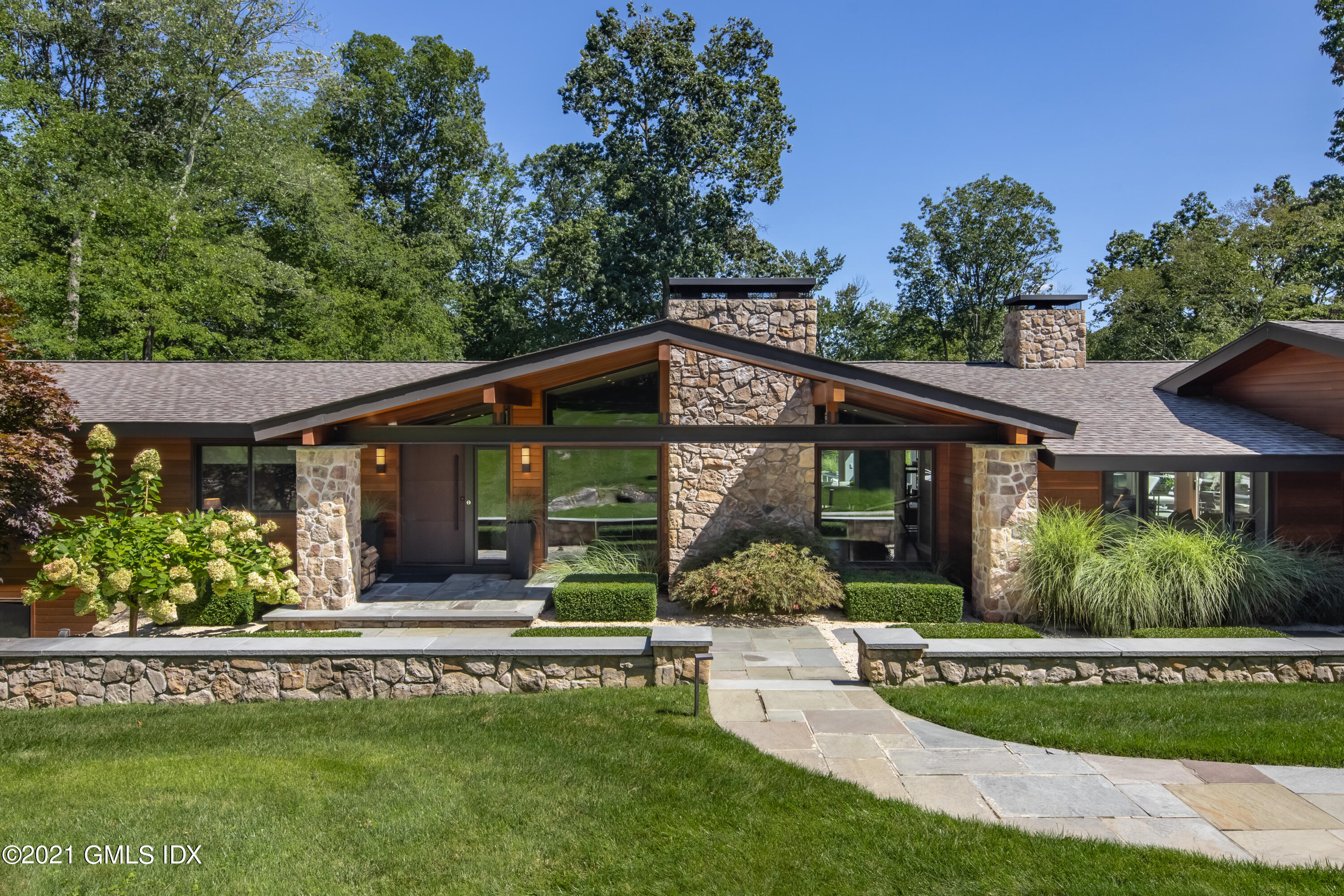 11 Old Forge Road Greenwich, CT 06830 - Photo 1 of 34 front view of a house with a garden