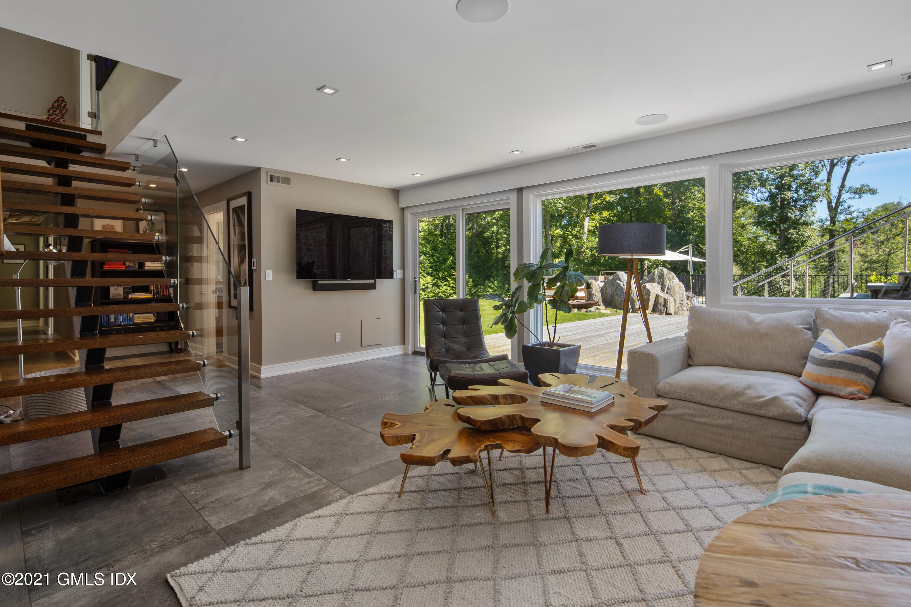 11 Old Forge Road Greenwich, CT 06830 - Photo 21 of 34 a living room with furniture a flat screen tv and floor to ceiling window
