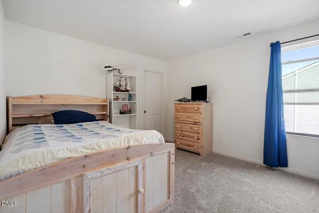 a bedroom with a bed and a cabinets