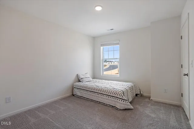 a bed room with a bed and a window