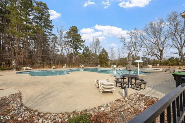 a view of a lake with tables and chairs