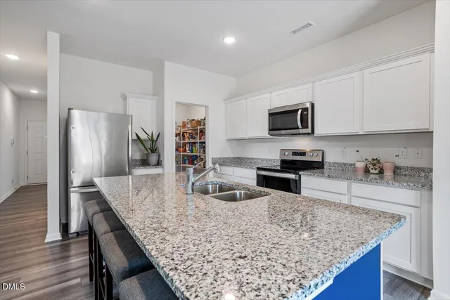 a kitchen with granite countertop a counter space and stainless steel appliances