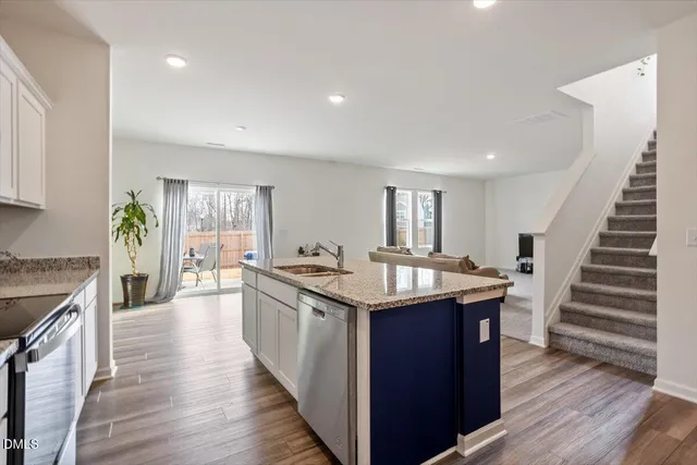 a kitchen with wooden floor and a sink