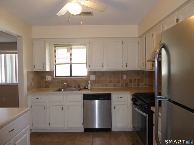 a kitchen with a sink stove and refrigerator