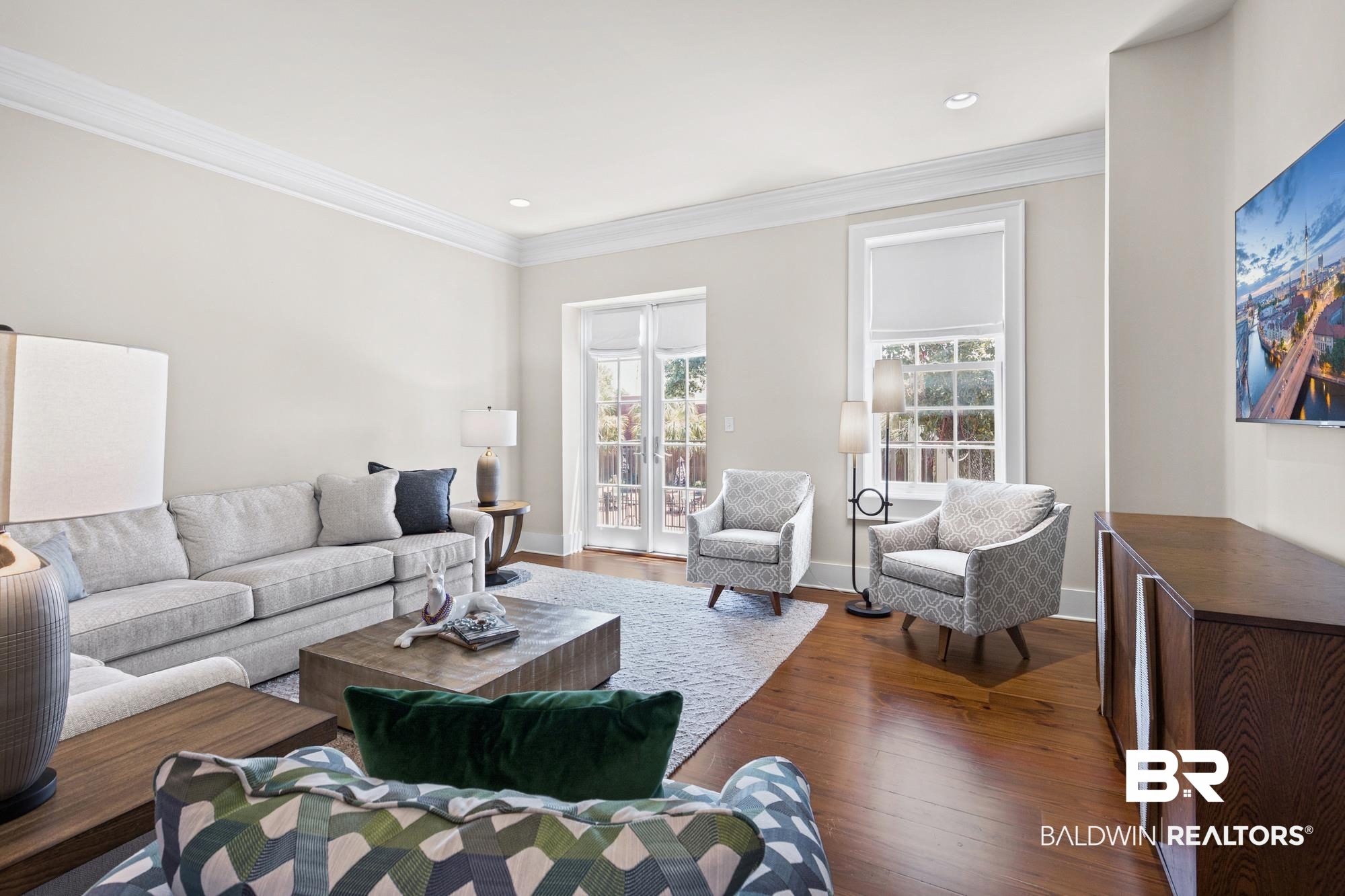 701 Dauphin Street, Unit A Mobile, AL 36602 - Photo 9 of 31 Living area featuring hardwood flooring, crown molding, recessed lighting, and white French doors