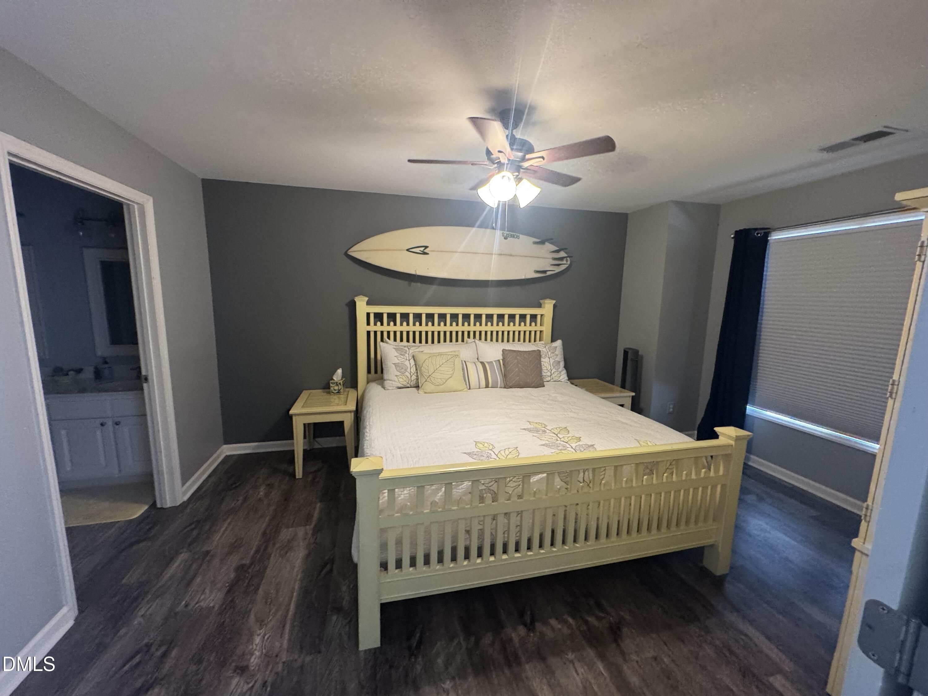 11351 Clubhaven Place, Unit 100 Raleigh, NC 27617 - Photo 18 of 29 a bedroom with a bed and wooden floor