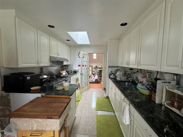 a kitchen with sink stove and cabinets