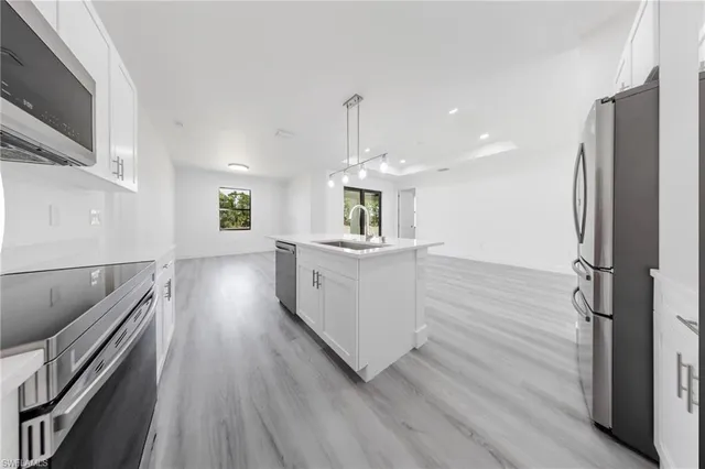 a bathroom with a double vanity sink toilet mirror and shower