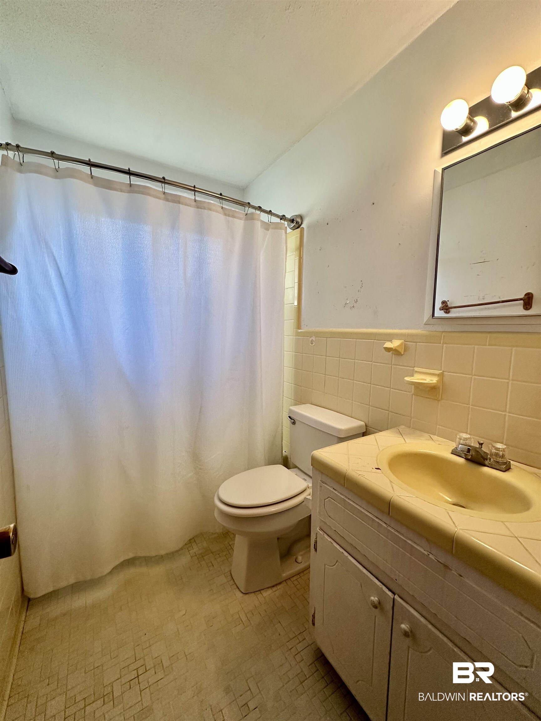 2664 Sowell Road Brewton, AL 36426 - Photo 8 of 12 Bathroom featuring toilet, vanity, and tile walls