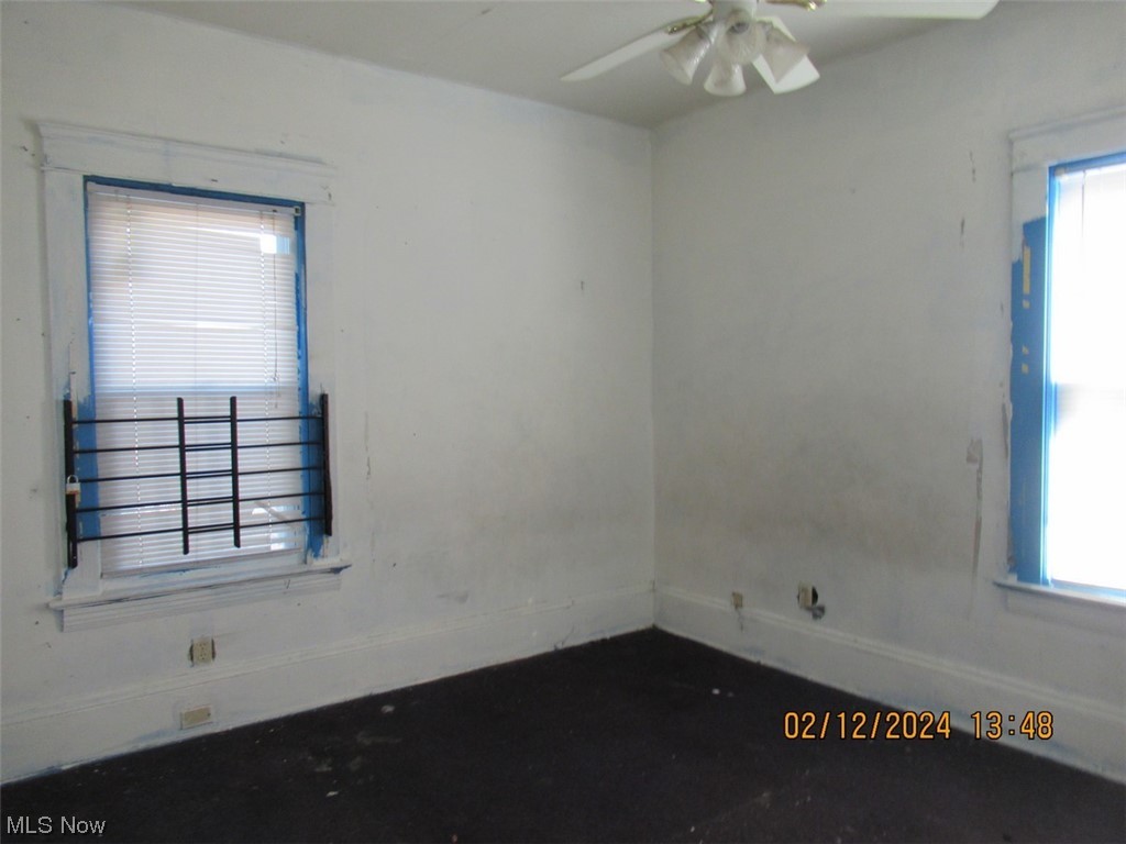 1863 Noble Road Cleveland, OH 44112 - Photo 7 of 16 Empty room featuring a healthy amount of sunlight and ceiling fan