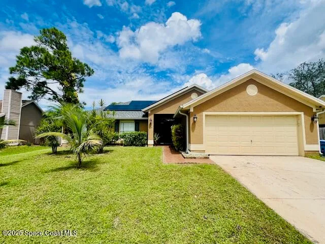 a front view of house with yard and green space