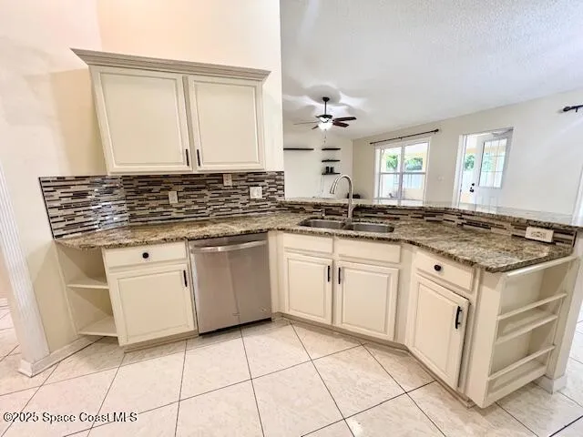 a kitchen with white cabinets and appliances
