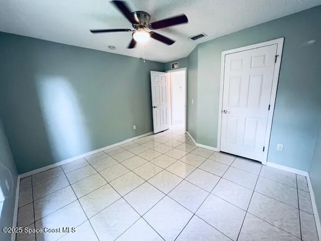 a view of a livingroom with a ceiling fan and window