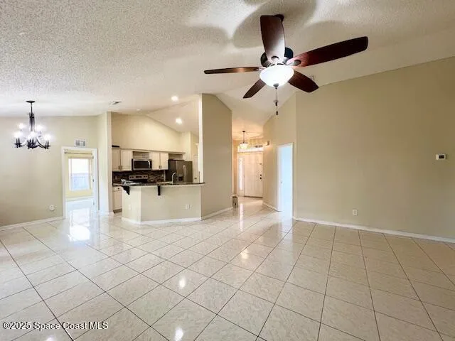 a view of kitchen refrigerator and microwave