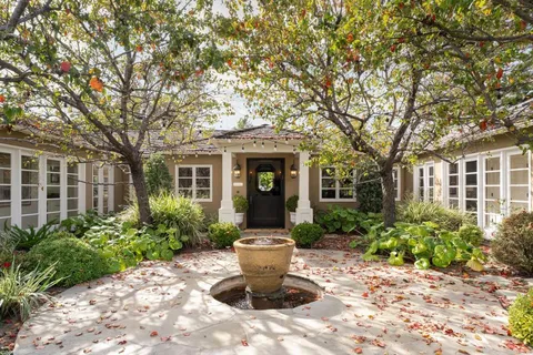 a front view of a house with garden