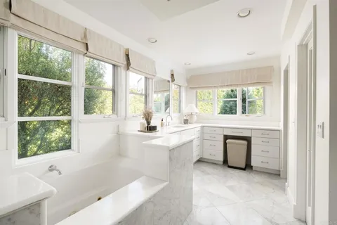 a bathroom with a tub sink and window