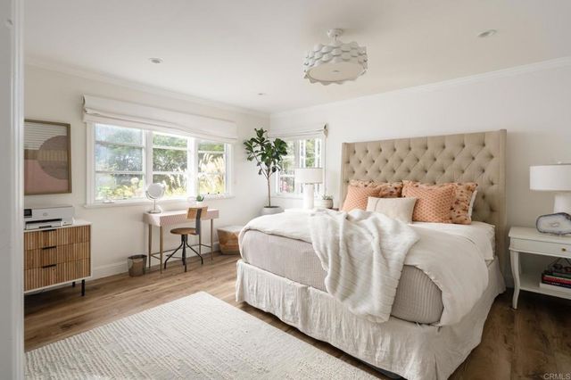 a bedroom with a bed and a table chair