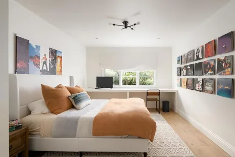 a bedroom with a large bed and a window