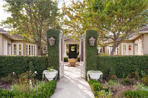 a view of a patio with couches table and chairs and potted plants