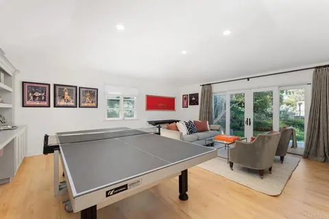 a living room with furniture pool table and a flat screen tv