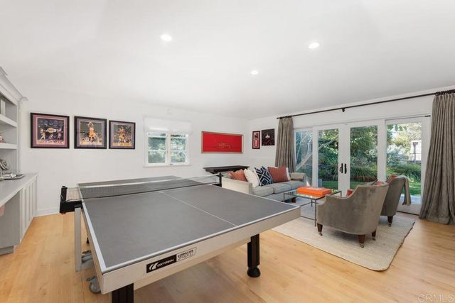 a living room with furniture pool table and a flat screen tv