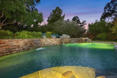 a view of a swimming pool with a yard