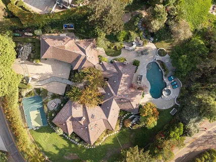 an aerial view of a house with yard swimming pool and outdoor seating