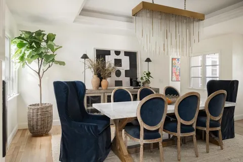 a view of a dining room with furniture and chandelier