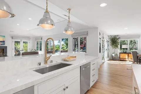 a view of a kitchen with a sink and wooden floor