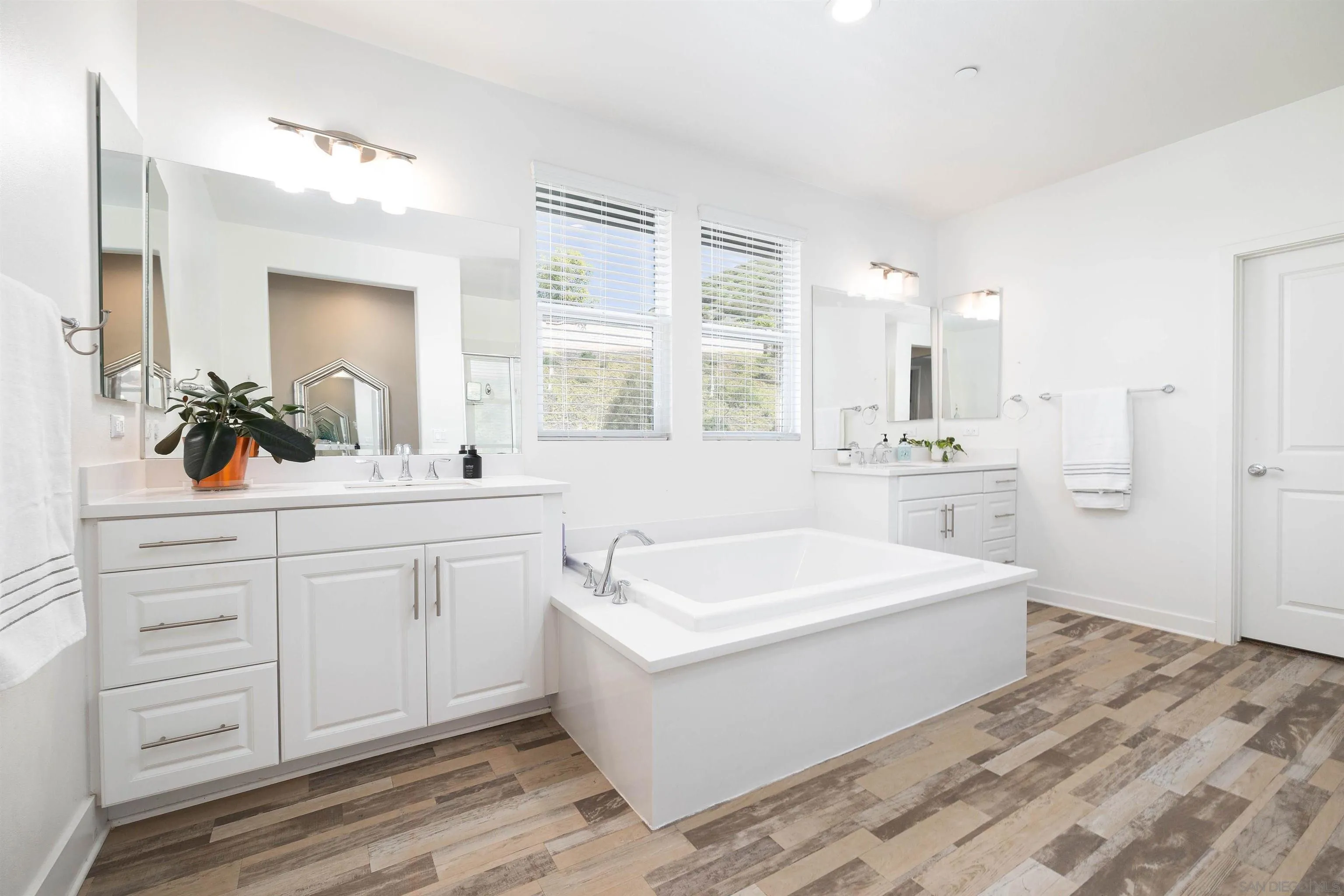 35763 Garrano Lane Fallbrook, CA 92028 - Photo 13 of 25 a spacious bathroom with a double vanity sink a mirror a bathtub and window