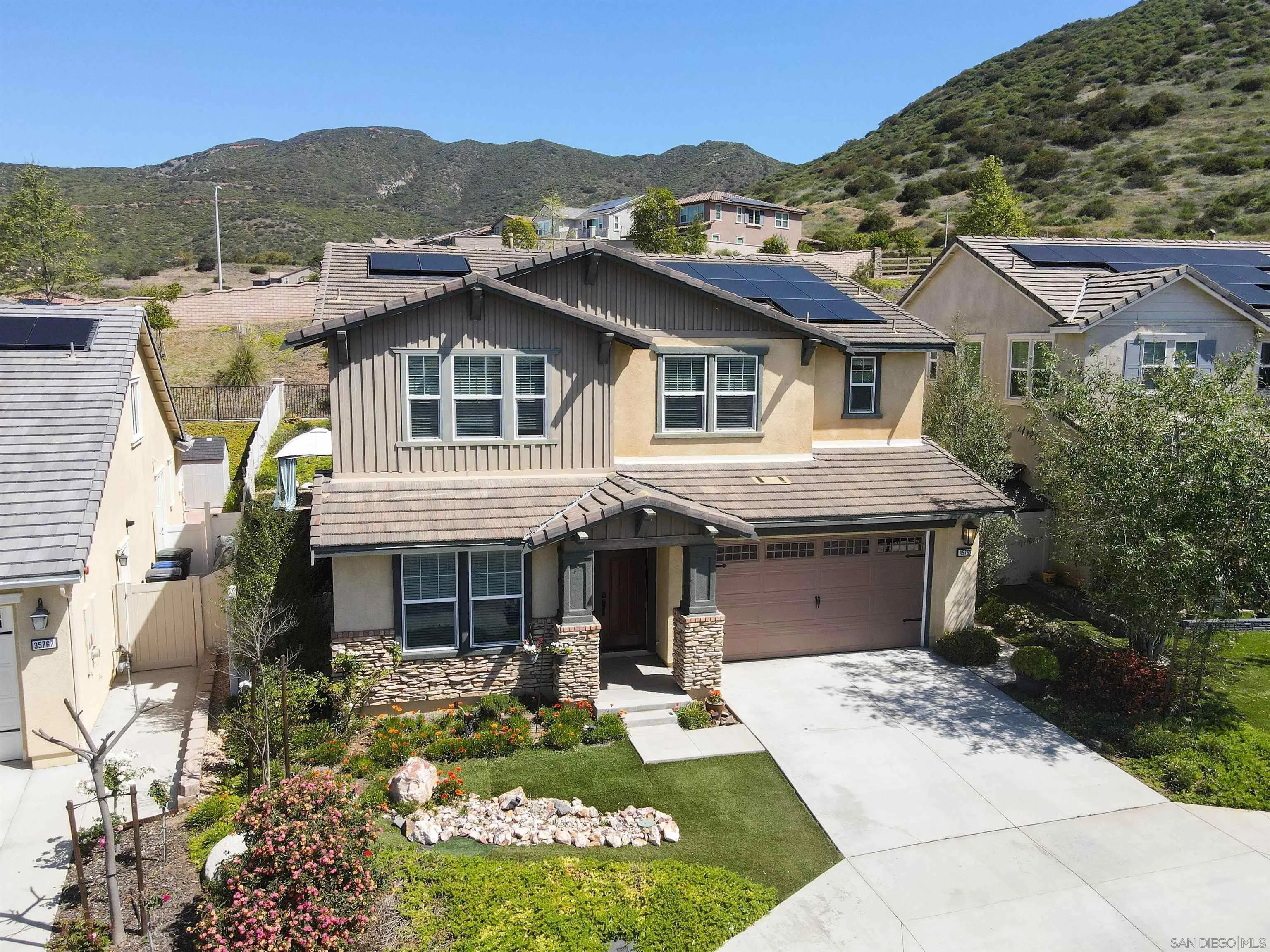 35763 Garrano Lane Fallbrook, CA 92028 - Photo 2 of 25 a front view of a house with a garden and plants
