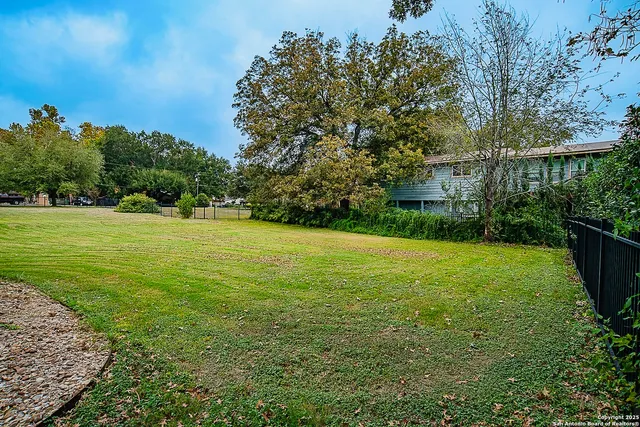 a view of a garden with a building in the background